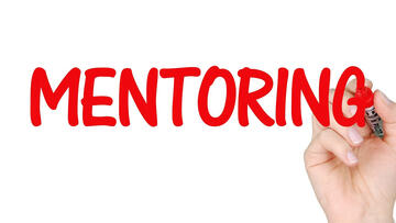 Rote Schrift auf Bildschirm zeigt Mentoring